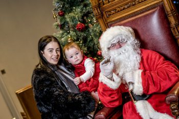 Santa with young mum and her baby attending the Family Nurse Partnership programme Christmas celebration event in the Guildhall, Londonderry.