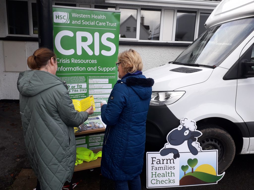 Health Improvement Officer Community Support, HIEI, Western Trust, providing a member of public with health information at the Farm Families health checks and health information event held in Seskinore