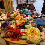 Selection of Handknitted twiddle muffs and blankets