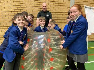 Year 8 Students From Sacred Heart College Omagh Enjoying The Body Zorb Pictured With Andy Brady PSNI