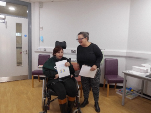 Service User receives their certificate for completing the Safer Eating and Drinking Programme from Janice McAllister