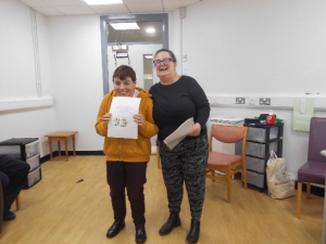 Service User receives their certificate for completing the Safer Eating and Drinking Programme from Janice McAllister
