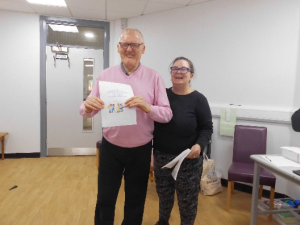 Service User receives their certificate for completing the Safer Eating and Drinking Programme from Janice McAllister