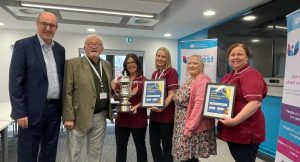 Acute Liaison Nurses being presented with the Mission Cup by Trust Chair Dr Tom Frawley and Chief Executive Neil Guckian