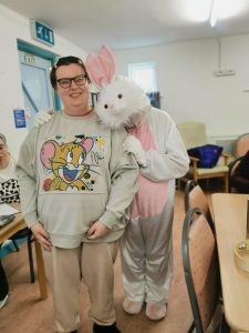 Service User with the Easter Bunny at Tir Navar Day Centre