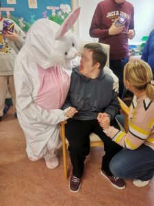 Service User and staff member with the Easter Bunny at Tir Navar Day Centre