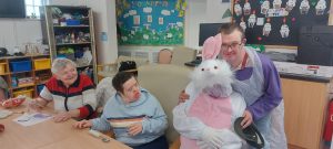 Service Users with the Easter Bunny at Tir Navar Day Centre