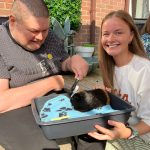 Service User and staff enjoying the visit from Kidz Farm