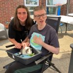 Service User and staff enjoying the visit from Kidz Farm