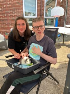 Service User and staff enjoying the visit from Kidz Farm