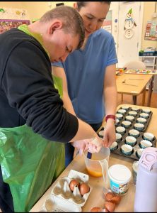 Service User And Staff Member Doing Some Christmas Baking