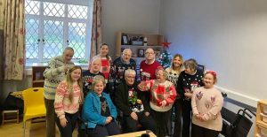 Service Users And Staff In Christmas Jumpers