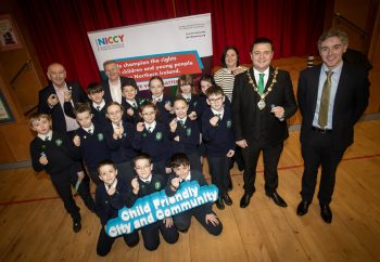 Primary 7 pupils at St. Patrick's Primary School, Derry pictured showing off their new badges at Wednesday's launch of the Pioneering Children's Rights and Wellbeing Programme across Derry and Strabane. Included at back are Tom Cassidy, Western Trust, Chris Quinn, Children's Commissioner, Clare Maguire, DCSDC, the Mayor, Ruairi McHugh and Mr. Ian Gallagher, Principal.