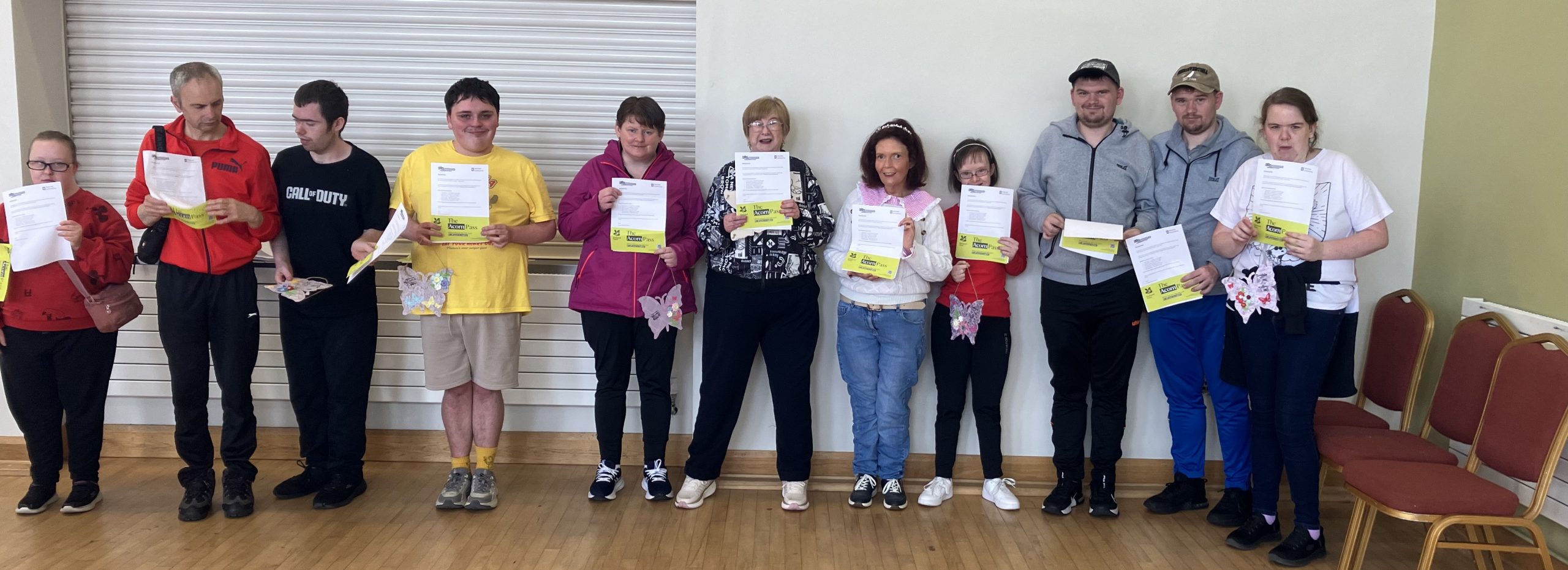Service Users with a Learning Disability holding their paper acorn passes