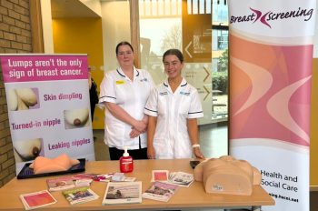 Two Breast Cancer Team Staff with pop up banner and information table