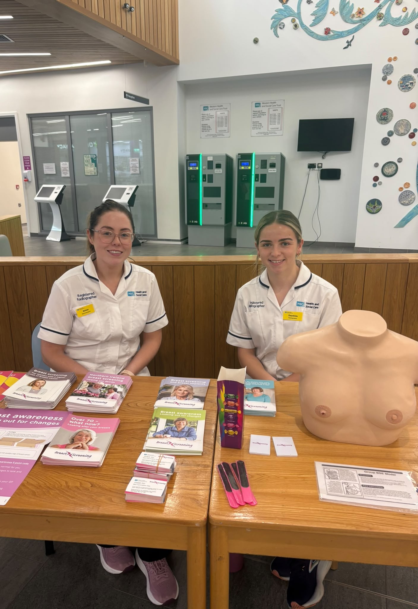 Two Breast Cancer Team Staff with information table